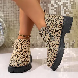 Stylish leopard print ankle boots with chunky black soles worn by a female model