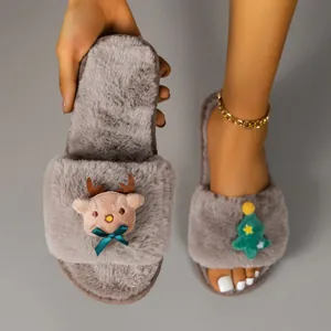 Close-up of grey fuzzy Christmas slippers featuring cute reindeer and tree patterns