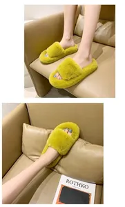 Close-up of bright yellow plush furry slippers being worn on a cozy leather sofa