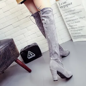 Detail view of grey suede over-the-knee stretch boots with a thick high heel