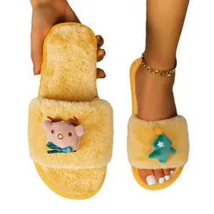 Soft yellow fuzzy Christmas slippers with cute reindeer and tree plush decorations.