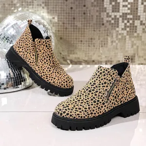 Close-up of leopard print ankle boots with a chunky black lug sole and gold zipper