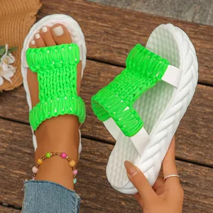 Macro view of neon green woven texture and white platform sole on casual women's slides