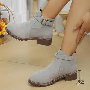 Detail of grey suede ankle boots featuring 3.8cm low block heel and buckle