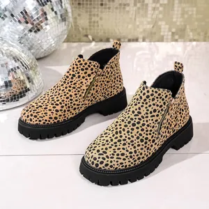 Stylish leopard print Chelsea boots featuring thick lug soles and side gold zipper detail