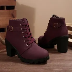 Side detail of burgundy combat boots with a chunky heel and metal buckle accents.