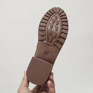 Detailed macro view of the brown anti-slip rubber sole for women's autumn Martin boots