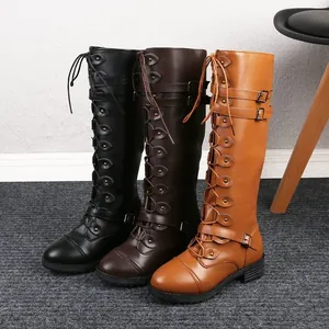 Three colors of women's flat knee-high riding boots with buckles and stud details.