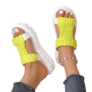 Chunky platform sandals with neon yellow woven straps and textured white soles