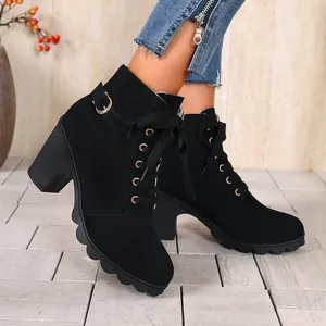 Side profile of women's black combat boots featuring chunky heel and metallic buckle