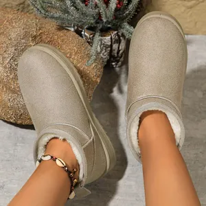 Detail of women's warm slip-on snow boots featuring faux fur lining and textured upper.