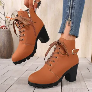 Stylish brown lace-up ankle boots for women with thick block heels and buckle detail.
