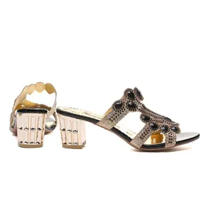 Side and rear view of elegant gold block heel sandals with black gemstone accents.