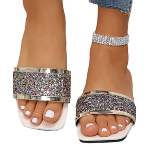 Stylish square-toe flat slides with vibrant glitter strap and metallic gold trim