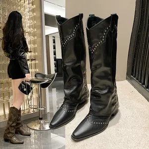 Detailed view of vintage black rivet tall boots for women in western cowboy style