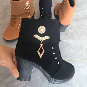 Black high-heeled ankle boot featuring an elegant pearl and rhinestone pendant detail