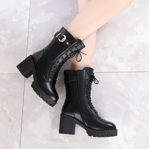 Elegant black leather Martin boots for women featuring chunky heels and platform soles