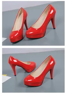 Glossy red round-toe pumps featuring high stiletto heels and a platform base design.