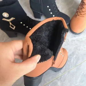 Close-up of warm black fleece lining inside high-heeled rhinestone ankle boots