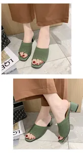 Vista dettagliata dei sabot da donna in maglia verde con tacco medio indossati con pantaloni