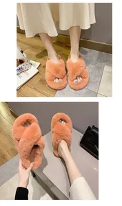 Detail of orange fuzzy cross-strap slippers worn by a model in a lifestyle setting