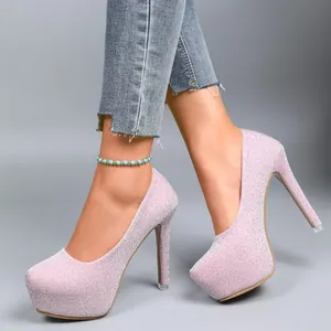 Sparkling pink glitter high heels featuring a thick platform and stiletto heel detail view
