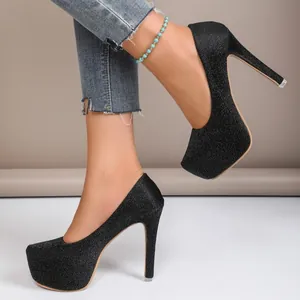 Side detail view of black glitter stiletto pumps with a high platform and sleek heel