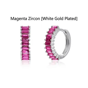 Close-up of elegant silver hoop earrings featuring rose red baguette-cut cubic zirconia.