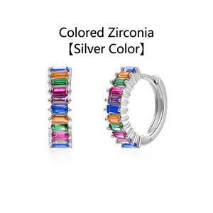 Close-up detail of silver hoop earrings set with vibrant multi-colored baguette zircons