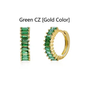 Front and side detail of emerald green baguette zircon gold plated huggie earrings.