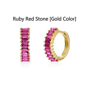 Detail view of elegant gold hoop earrings featuring vibrant rose red baguette zircons.