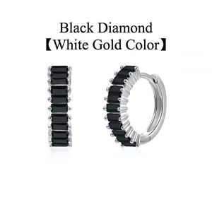 Detailed macro view of black baguette-cut zircon hoop earrings in white gold finish