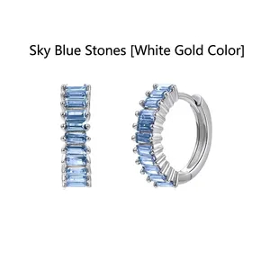 Detailed macro view of baguette-cut sky blue zircon hoop earrings in elegant silver finish
