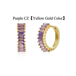 Close-up detail of gold hoop earrings featuring elegant baguette-cut purple zircon stones.
