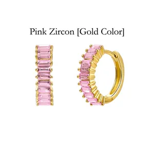 Detail view of gold-plated hoop earrings featuring emerald-cut pink cubic zirconia