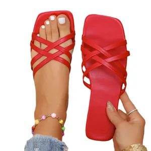 Elegant red flat sandals featuring a square toe and cross straps for summer wear