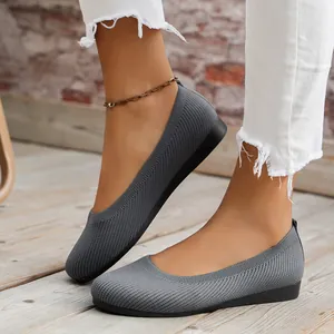Close-up detail of grey breathable knitted ballet flats with comfortable round toe design.