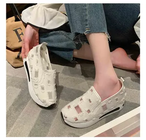 Detail view of women's white platform loafers with distressed mesh patchwork design