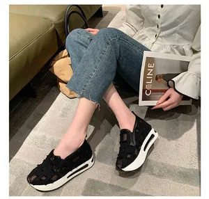 Close-up of casual black platform loafers with unique patchwork mesh design details