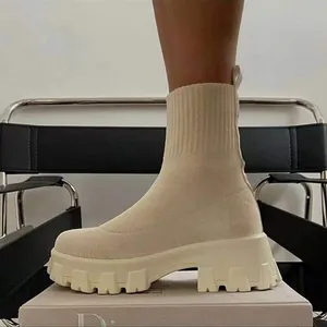 Detailed view of beige fly-knit sock boots with chunky platform lug soles for women