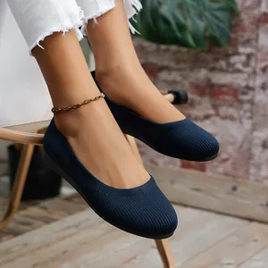 Close-up detail of navy blue knit flat shoes with comfortable round toe and soft material