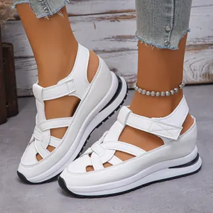 Detailed view of women's white Roman platform sandals with velcro straps and hollow design.