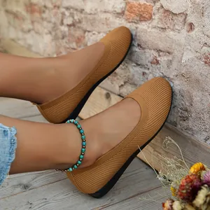 Elegant brown knitted flat shoes featuring a comfortable round toe design for women