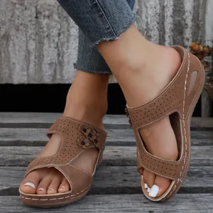 Comfortable brown women's wedge sandals with flower accents and perforated suede