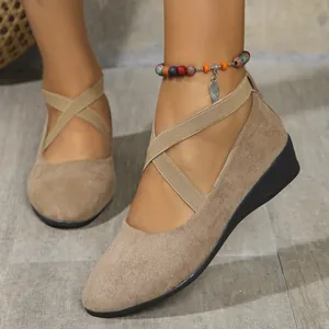 Detailed shot of women's beige pointed-toe wedge shoes with elastic cross straps