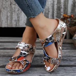 Close-up of women's wedge sandals with vibrant multicolor snake skin pattern and platform sole