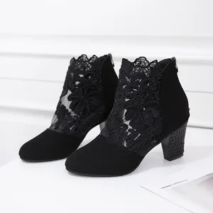 Detailed view of elegant black lace mesh chunky heel ankle boots with floral embroidery