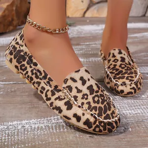 Detailed close-up view of leopard print loafers featuring elegant white stitching detail
