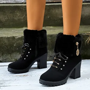 Detailed view of black chunky high heel ankle boots with faux fur and rhinestones