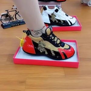 Detailansicht von Chunky-Sneakern mit goldener Tigerstickerei und atmungsaktivem Mesh